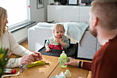 Toddler with down syndrome sitting at table