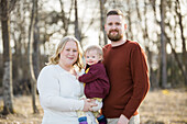 Outdoor portrait of family with baby with down syndrome