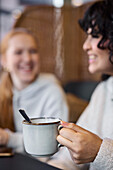 Female friends drinking coffee in cafe