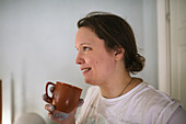 Smiling woman having coffee