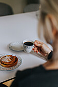 Hand holding coffee cup