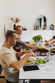 Group of friends eating Mexican food at home