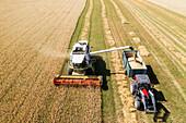 Aerial view of combine harvester working in field
