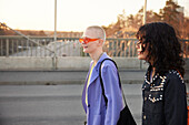 Smiling young women walking together