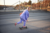 View of young woman skateboarding