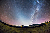 The Zodiacal Light in the the late autumn evening sky from Arizona, overlooking the Chiricahua Mountains near Portal, AZ. The Zodiacal Light exends up from the horizon to the angled following the ecliptic. The summer Milky Way setting into the southwest extends up from the horizon to the right, running through the middle of the Summer Triangle stars. A satellite streaks across the Zodiacal Light, in a flaring path. I shot this from the field at Quailway Cottage.