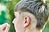 Close-up detail of a young caucasian boy's haircut style. Lifestyle concept.