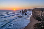 The setting Sun at the Twelve Apostles sea stacks and cliffs on the Great Ocean Road, on April 12, 2017.