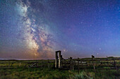 Mars (bottom) and Saturn in conjunction at right, and the Milky Way at left, in deep blue twilight before the sky got filly dark, over the old corral of the 76 Ranch, in Grasslands National Park, Saskatchewan, August 27/28, 2014. Antares and Scorpius are just behind the corral gate at right, Sagittarius is at left in the Milky Way. M6 and M7 open cluster are visible at left.