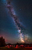 A vertical panorama of the summer Milky Way over the observing field at the Saskatchewan Summer Star Party, held in Cypress Hills Interprovincial Park in southwest Saskatchewan, Canada, at a latitude 49° N. The Park is a Dark Sky Preserve. This was August 26, 2022 on a perfect night of stargazing under very clear skies. The Milky Way extends from Sagittarius near the horizon, to Cygnus nearly overhead at this time, so a vertical sweep of 90°. I've left the satellite trails in for this scene.