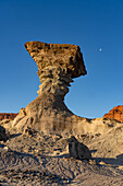 Moon over the Hongo or Mushroom, an eroded geologic formation in Ischigualasto Provincial Park, San Juan, Argentina.