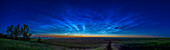 A superb and extensive "grand display" of noctilucent clouds at dawn on July 16, 2022, with the clouds eventually reaching up to the zenith as the sky brightened. Many ripples and wave structures are visible in the clouds.
