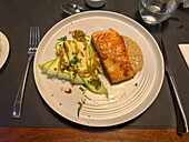Salmon with an almond sauce and zucchini with a honey mustard sauce in a restaurant in San Rafael, Argentina.