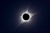 A composite of the August 21, 2017 total solar eclipse showing third contact – the end of totality – with sunlight beginning to reappear and the array of pink prominences along the limb of the Sun. Seconds later the emerging Sun and diamond ring overwhelmed the large prominence.