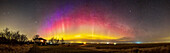 A 150° panorama of the auroral arc across the northern sky, shot from home in Alberta on April 27, 2022. The camera picked up the blue colour at the top of the curtains at left in the northwest from high-altitude sunlight illuminating the tops of the curtains. Otherwise, oxygen reds and greens dominate this fairly quiet display. Coincidentally, the arc of the aurora nicely follows the arc of the Milky Way across the north, then at its lowest for the year in the spring sky.