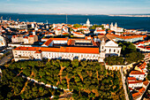 Aerial drone view of Miradouro da Graca with National Pantheon visible and large cruise ship moored on the Tagus River harbour, Lisbon, Portugal, Europe