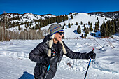 USA, Idaho, Ketchum, Senior female hiker hiking in mountains in winter
