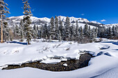 USA, Idaho, Sun Valley, River flowing in mountains in winter