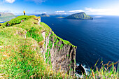 One person admiring the view standing on cliffs above the ocean, Nordradalur, Streymoy Island, Faroe Islands, Denmark, Europe