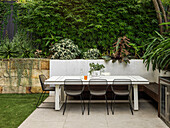 Table with chairs and bench on the terrace