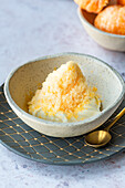 Grated frozen clementine on whipped cream