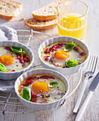 Baked eggs with tomatoes and basil