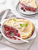 Baked rice pudding with forest fruit and meringue topping