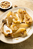Roasted pears with walnuts and ginger syrup