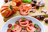 Tomatoes (ox hearts and black lady) sliced with basil and garlic