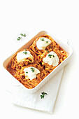 Tagliatelle with meat sauce and baked Provolone
