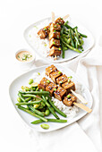 Tofu satay on rice with broad beans and green beans