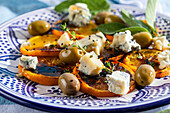 Salad with grilled orange slices, cheese, and olives