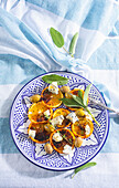 Salad with grilled orange slices, cheese and olives