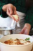 Preparing green lasagna with parmesan (Emilia-Romagna)