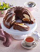 Cocoa sponge bundt cake with curd cheese and peaches