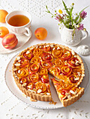Rose tart with apricots, peaches and almonds