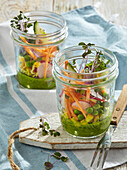 Vegetable salad in a glass jars with mint-avocado dip