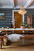 Rustic dining room furnishings with chandelier and candles