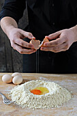 Making noodle dough: Adding the egg to the flour