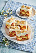 Walnut cake slices with lemon cream and strawberries