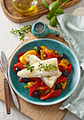 Marinated sea bass fillets with roasted peppers and olives