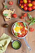 Fried egg with tomato fillet and basil pesto