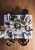 Set table with salad, cheese, and walnut bread