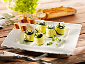 Courgette rolls with cream cheese and spinach leaves