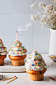 Cupcakes with vanilla frosting and sugar sprinkles