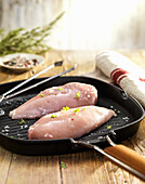 Chicken breast with spices in a pan