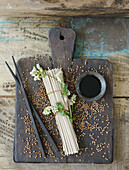 Uncooked buckwheat noodles (soba noodles) with flowering buckwheat twig