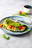 Spinach omelette with chicken fillet and vegetables