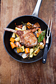 Lamb chop with vegetables in a pan