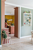 View of kitchen from dining room with pastel green walls